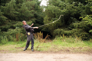 A slinging expert tests a replica sling (Image: John Reid via Current Archaeology)